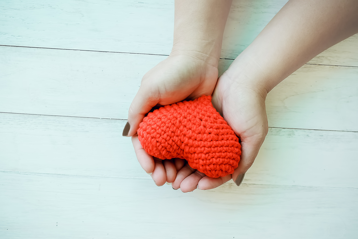 Female Hands Holding a Red Heart.
